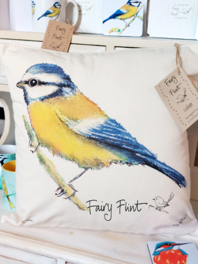 Canvas natural cushion with eco friendly ink print of Blue tit by Fairy Flint, cushion on dresser with other blue tit mug behind