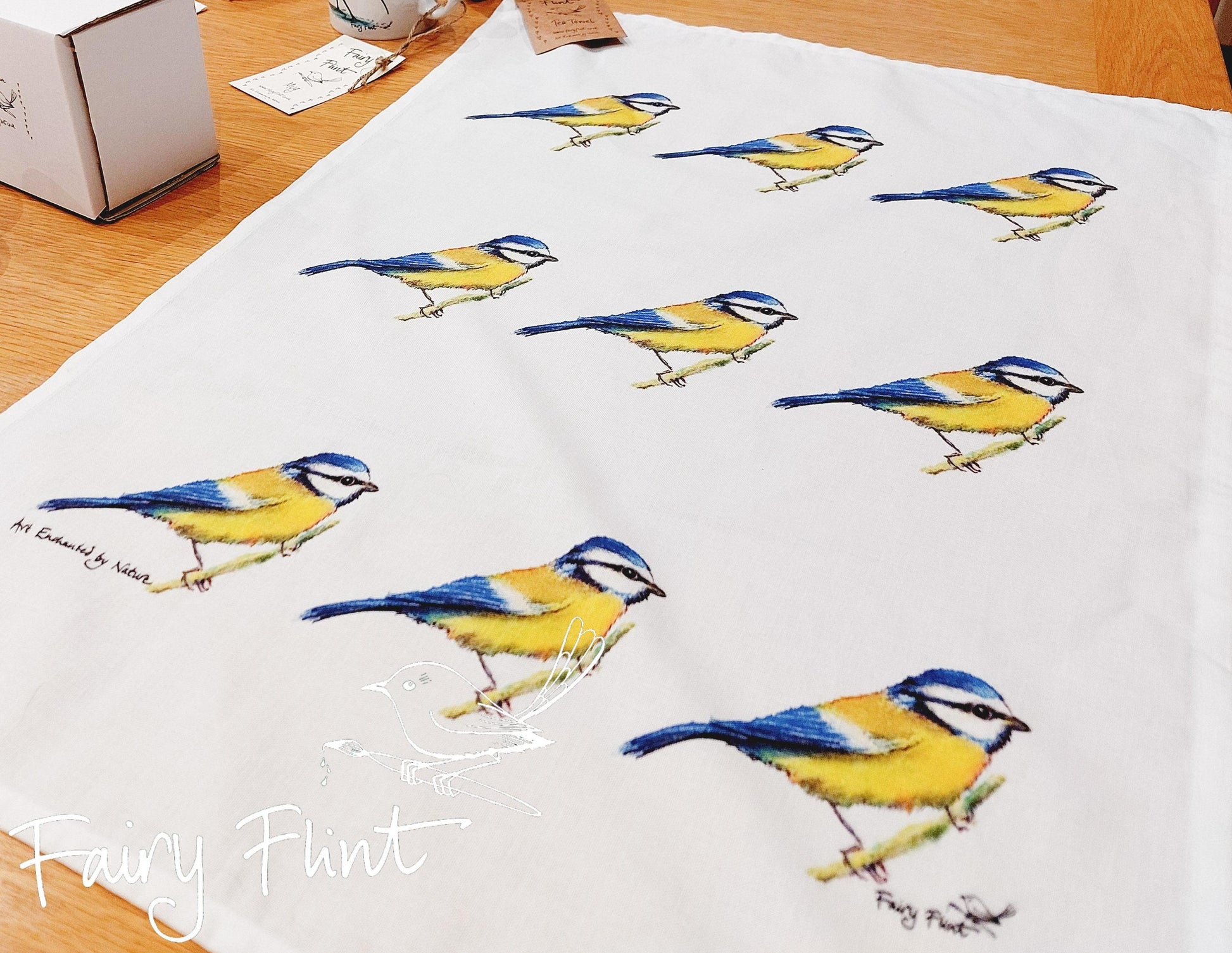 Natural tea towel with blue tit design by Fairy Flint repeated 9 times, printed with eco friendly inks, photoshoot at Eaton Manor, Shropshire