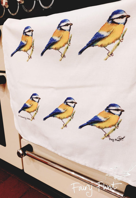 Natural tea towel with blue tit design by Fairy flint repeated 9 times, photoshoot at Eaton Manor, Shropshire, tea towel hanging over oven handle on range cooker printed with eco friendly inks