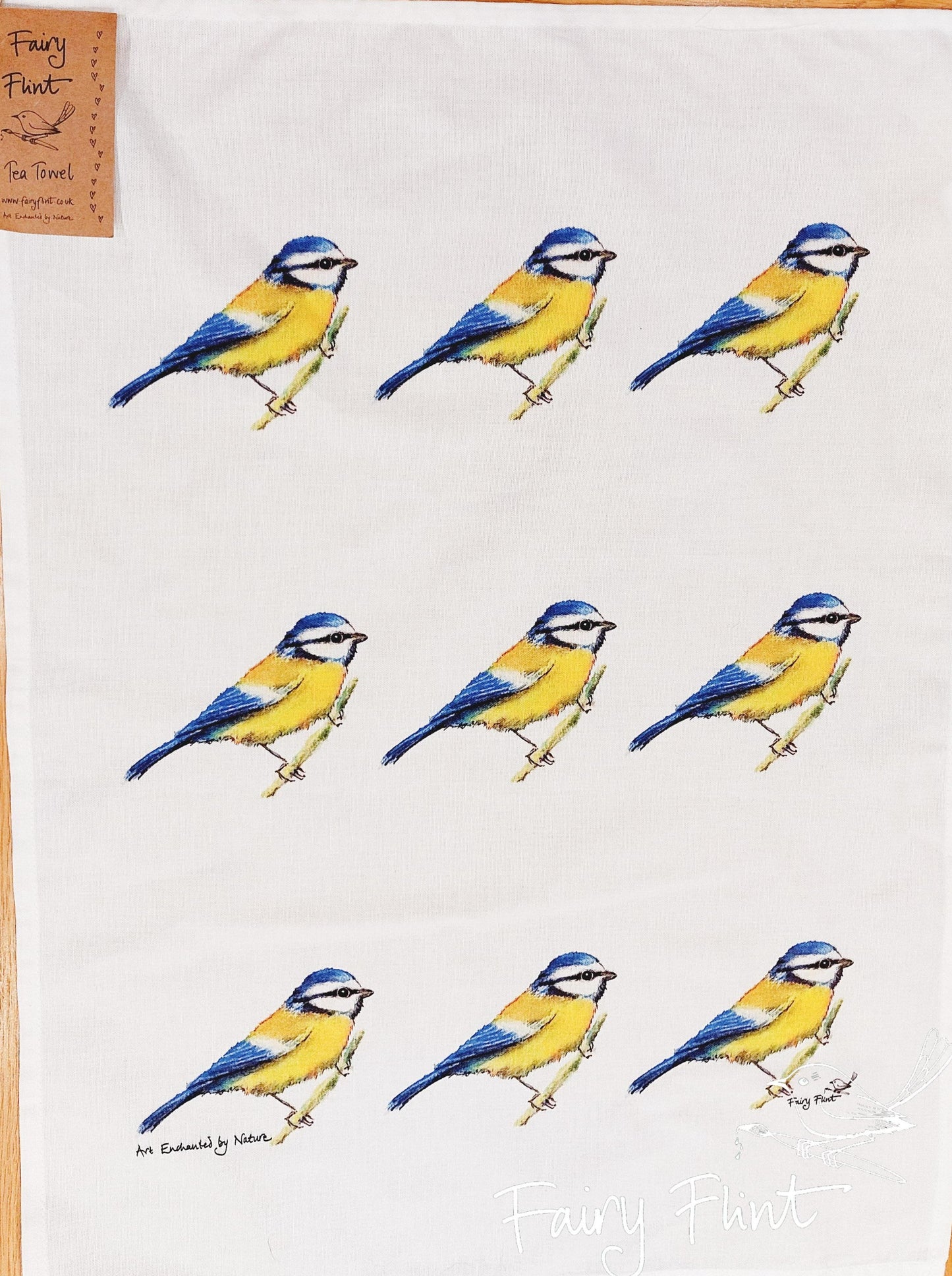 Natural tea towel with blue tit design by Fairy Flint repeated 9 times, printed with eco friendly inks, photoshoot at Eaton Manor, Shropshire