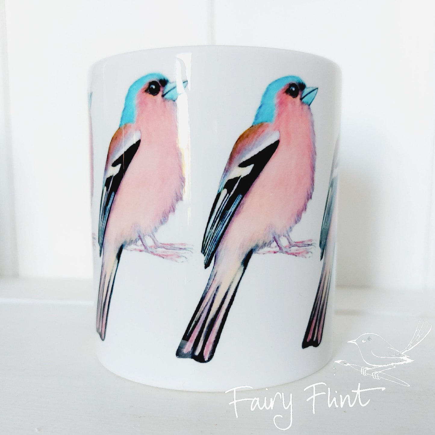 Ceramic mug with Chaffinch painting by Fairy Flint repeated round the mug, printed withy eco friendly inks