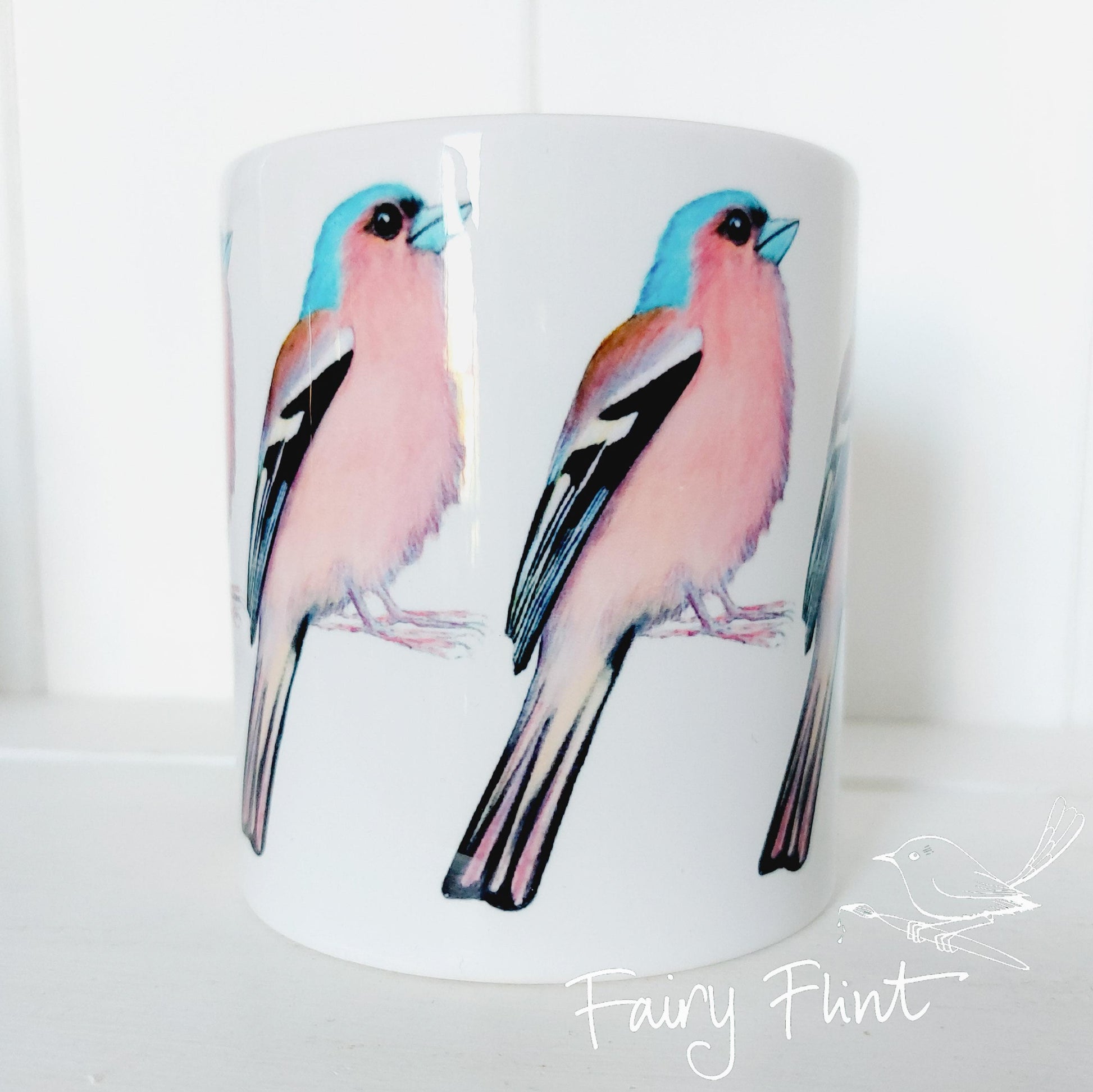 Ceramic mug with Chaffinch painting by Fairy Flint repeated round the mug, printed withy eco friendly inks