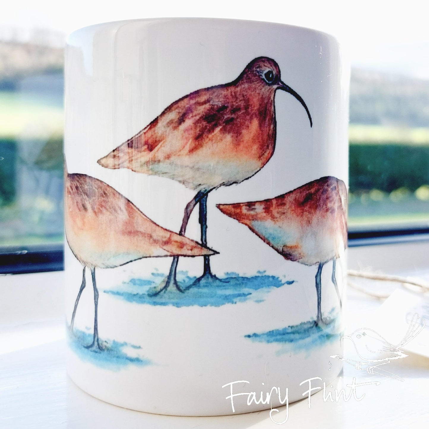 Ceramic mug with Curlew painting by Fairy Flint, printed withy eco friendly inks, photoshoot at Eaton Manor, Shropshire, Wenlock edge in the background