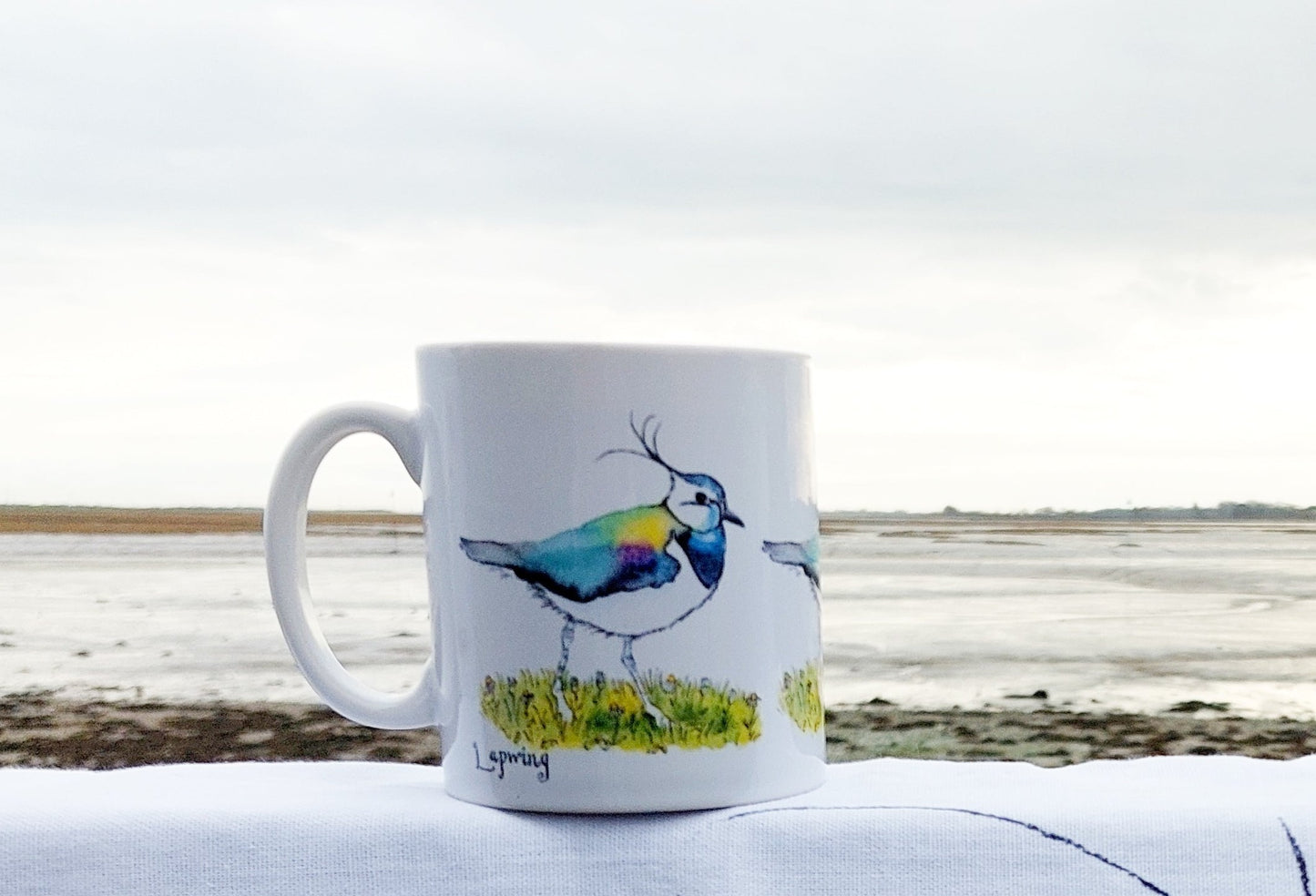 Lapwing on mug with sea behind at Emsworth by Fairy Flint 