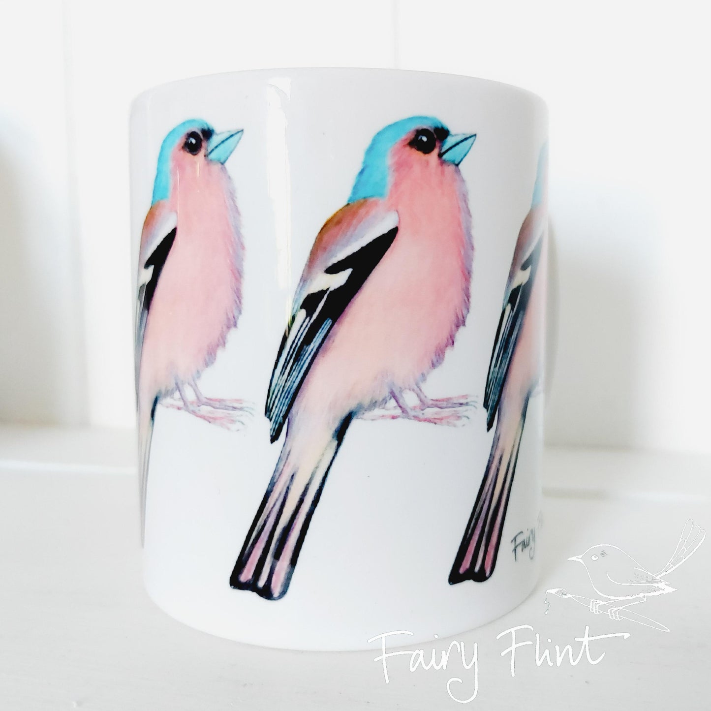 Ceramic mug with Chaffinch painting by Fairy Flint repeated round the mug, printed withy eco friendly inks