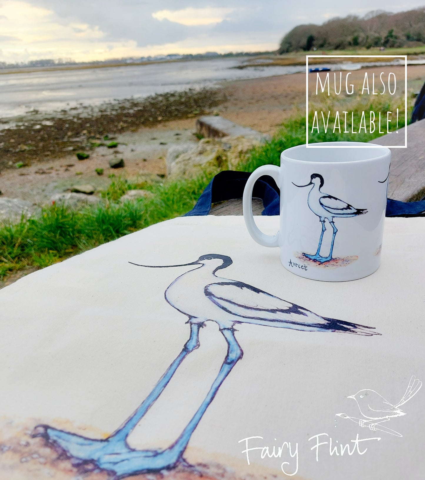 Canvas bag with Avocet painting eco friendly print by Fairy Flint with Ceramic mug on bench at Emsworth beach