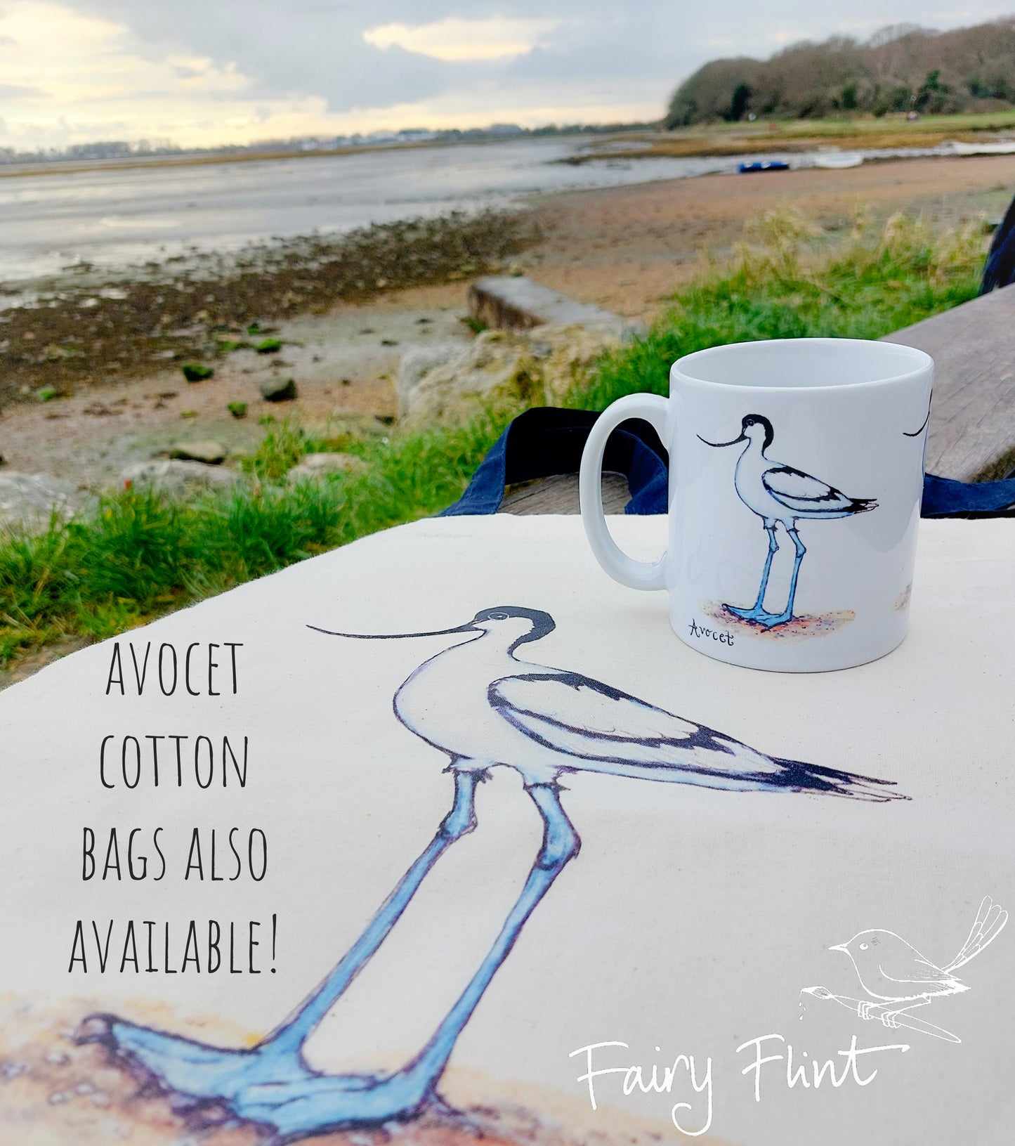 Ceramic mug with Avocet painting eco friendly print by Fairy Flint, photoshoot at Emsworth, mug standing on Canvas Avocet bag, coastline, beach and sea in background