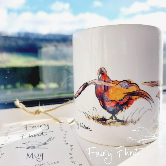 Ceramic mug with eco print of a fun Pheasant painting design by Fairy Flint photoshoot at Eaton Manor Shropshire, Wenlock Edge behind the mug